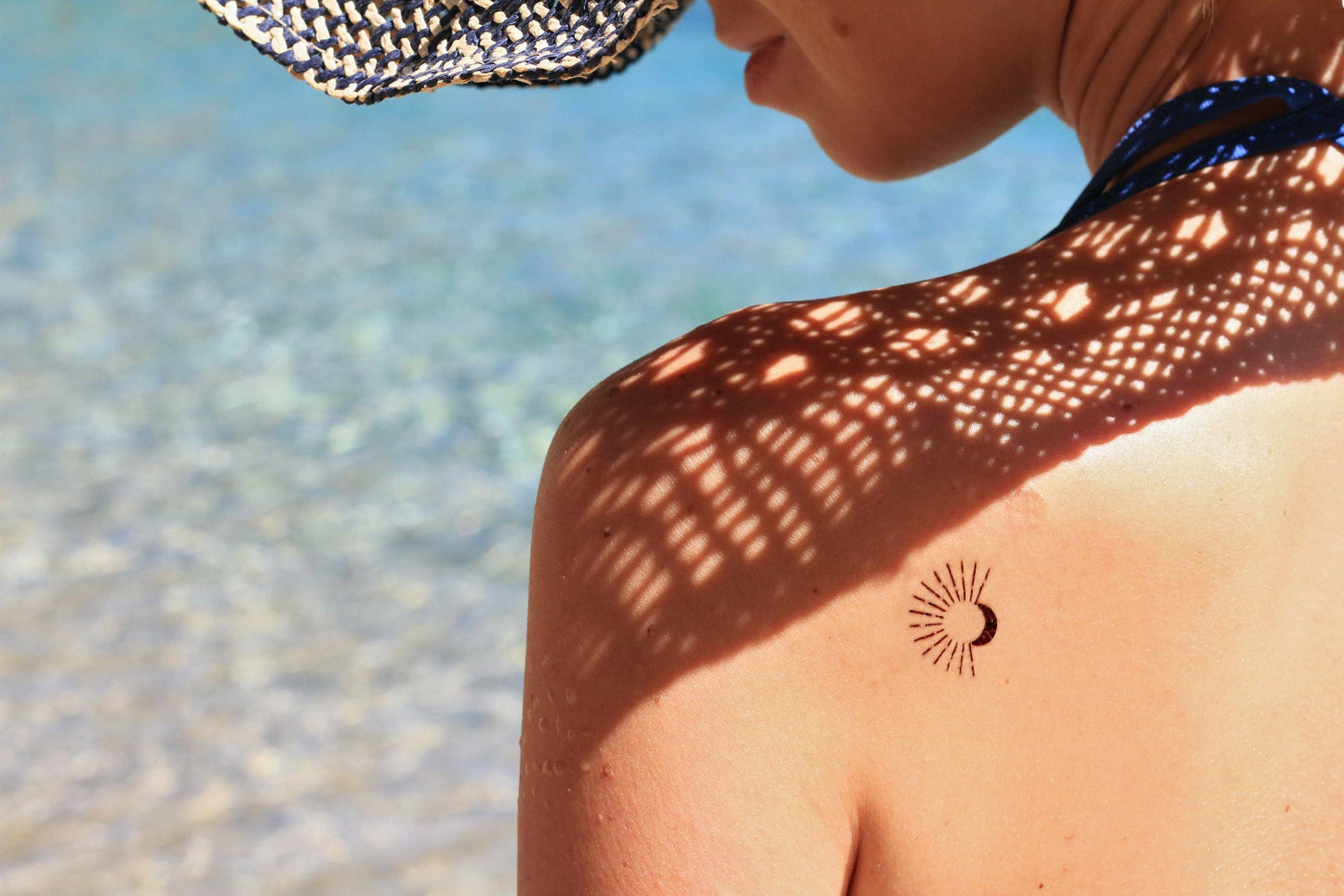 Temporary tattoo of a moon and a sun with rays