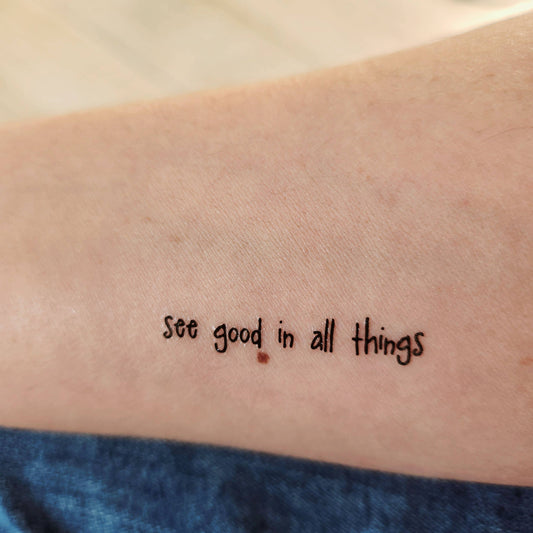 Temporary tattoo of the phrase "see good in all things"
