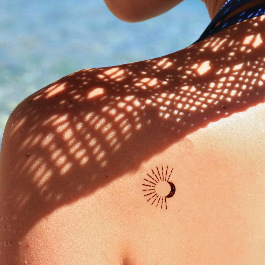 Temporary tattoo of a moon and a sun with rays