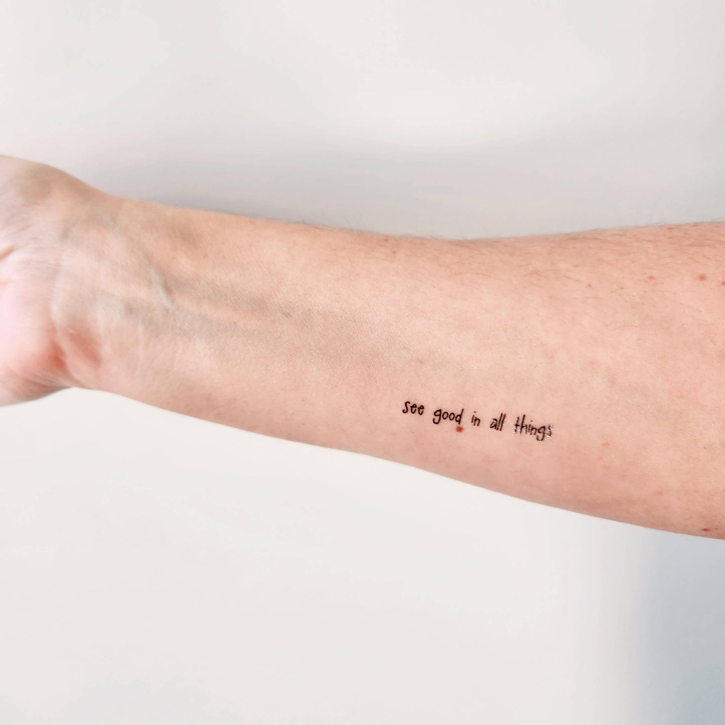 Temporary tattoo of the phrase "see good in all things"